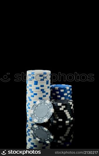 Stack of Casino gambling chips isolated on black.. Stack of Casino gambling chips isolated on black