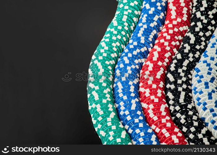 Stack of Casino gambling chips isolated on black reflective background.. Stack of Casino gambling chips isolated on black reflective background