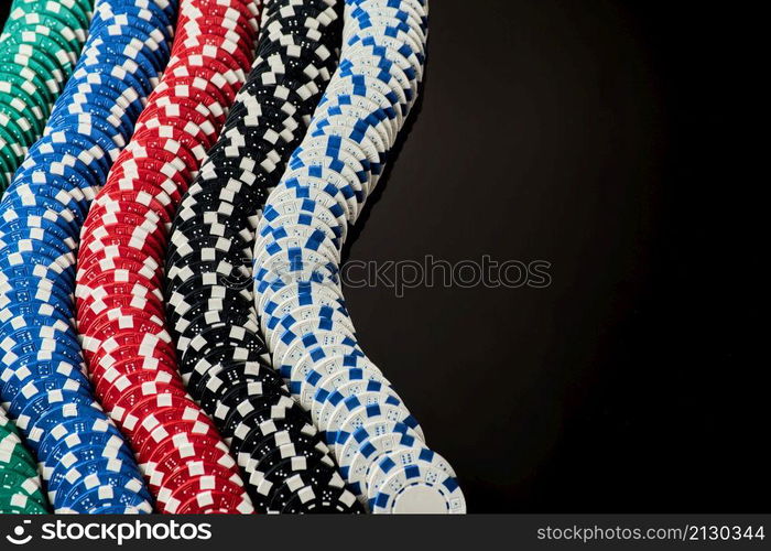 Stack of Casino gambling chips isolated on black reflective background.. Stack of Casino gambling chips isolated on black reflective background