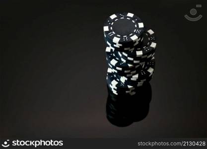 Stack of Casino gambling chips isolated on black reflective background.. Stack of Casino gambling chips isolated on black reflective background
