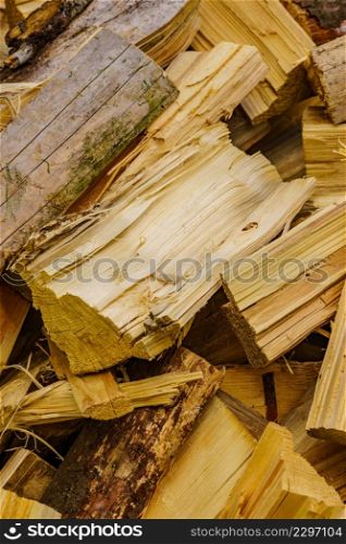 Stack of chopped firewood outside. Preparation for winter.. Stack of firewood on green grass.