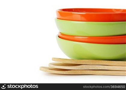 stack of clean empty plates and wooden spoons isolated on white background
