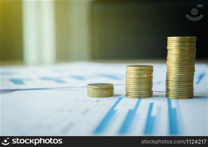 stack of coin on business document graph. Money and financial concepts.
