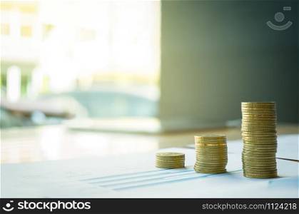 stack of coin on business document graph. Money and financial concepts.