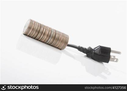 Stack of coins with a three pin plug