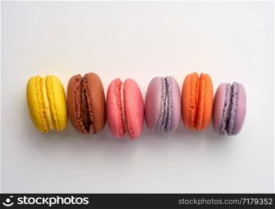 stack of colorful baked macaron almond flour on a white background, copy space, flat lay