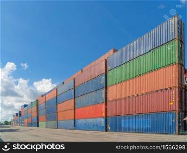 Stack of colorful container cargo ship in the export and import business and logistics international goods in urban city. Shipping to the harbour by crane.