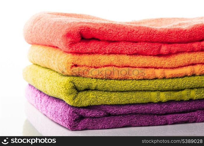 Stack of colorfull towels isolated on white