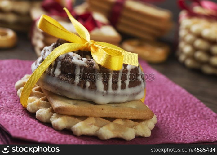 Stack of delicious cookies on table tied with ribbon. Sweet surprise