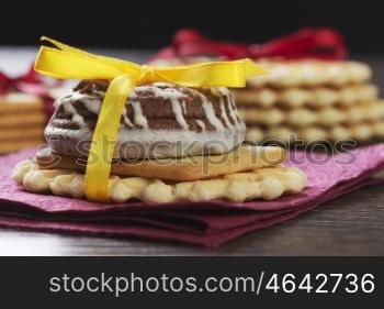 Stack of delicious cookies on table tied with ribbon. Sweet surprise