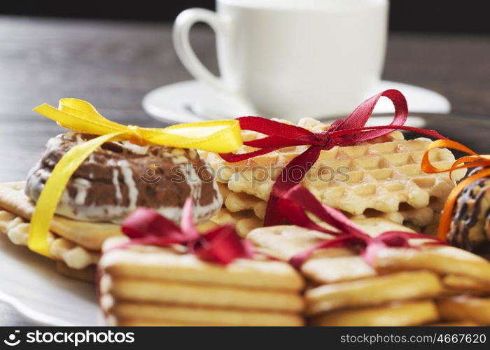 Stack of delicious cookies on table tied with ribbon. Sweet surprise