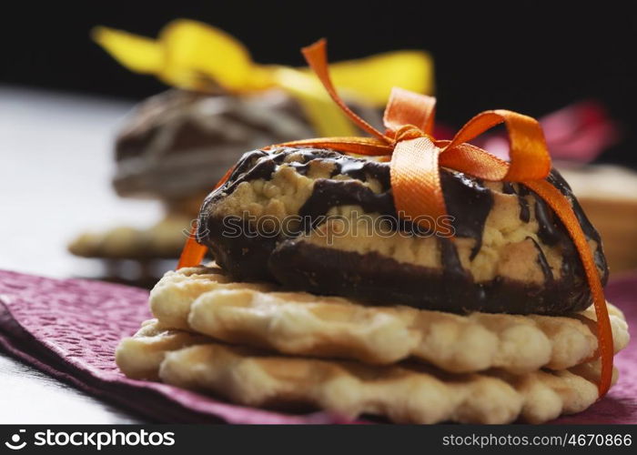 Stack of delicious cookies on table tied with ribbon. Sweet surprise