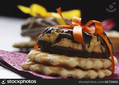 Stack of delicious cookies on table tied with ribbon. Sweet surprise