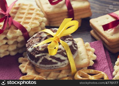 Stack of delicious cookies on table tied with ribbon. Sweet surprise