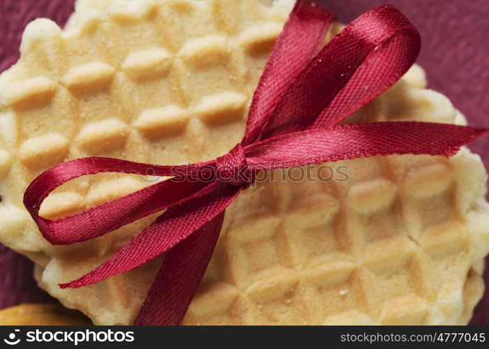 Stack of delicious cookies on table tied with ribbon. Sweet surprise