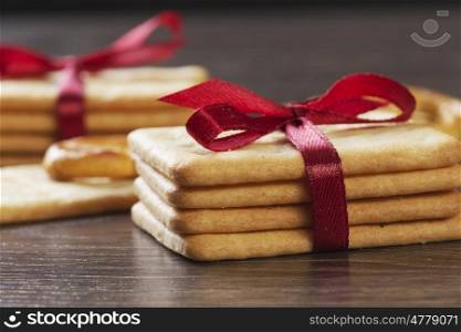 Stack of delicious cookies on table tied with ribbon. Sweet surprise