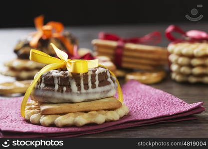 Stack of delicious cookies on table tied with ribbon. Sweet surprise