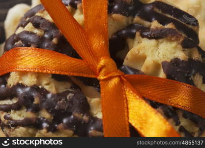 Stack of delicious cookies on table tied with ribbon. Sweet surprise