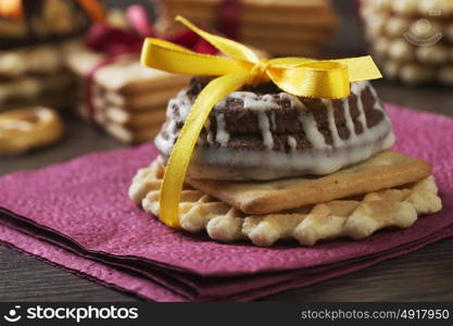 Stack of delicious cookies on table tied with ribbon. Sweet surprise