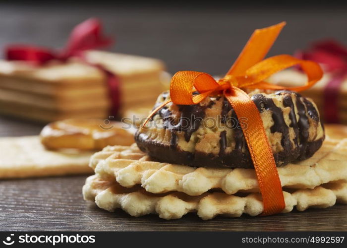 Stack of delicious cookies on table tied with ribbon. Sweet surprise