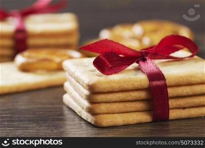 Stack of delicious cookies on table tied with ribbon. Sweet surprise