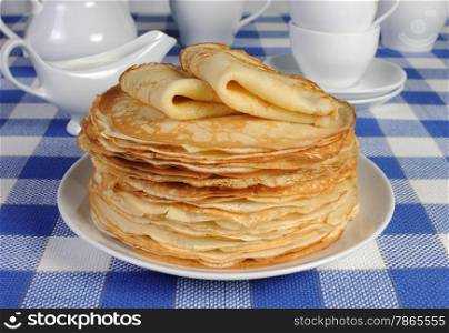 stack of delicious pancakes on the table with sour cream