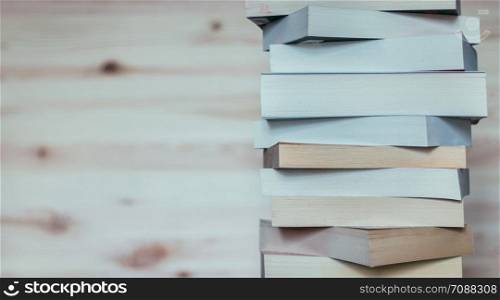 Stack of different books on wooden table: Literature for study