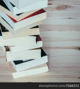 Stack of different books on wooden table: Literature for study