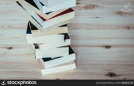 Stack of different books on wooden table: Literature for study