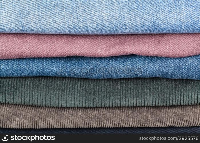stack of different denims and corduroys close up