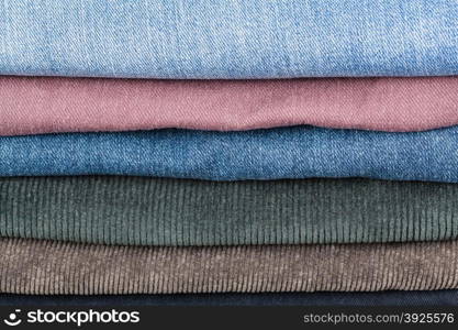stack of different denims and corduroys close up