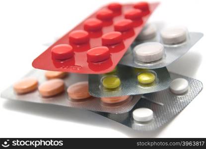 Stack of different tablets on white background