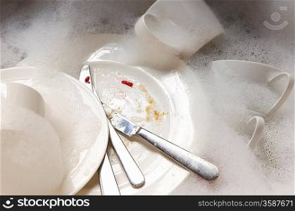 Stack of Dirty Dishes in Sink