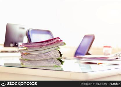 Stack of documents placed on a business desk in a business office.