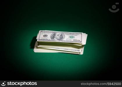 Stack of dollars on green table