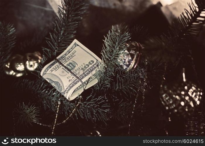 Stack of dollars under the Christmas fir