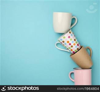 stack of empty ceramic cup on a blue background, flat lay