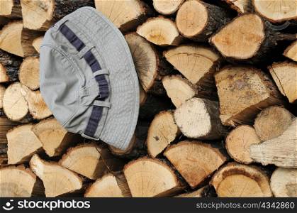 Stack of firewood and a hat