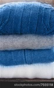 stack of folded woolen clothes close up. woolen clothes