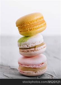 Stack of french colorful macaroons on stone