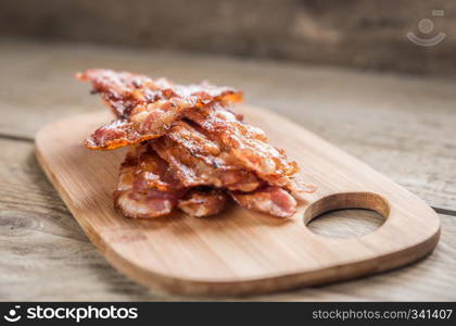 Stack of fried bacon strips on the plate