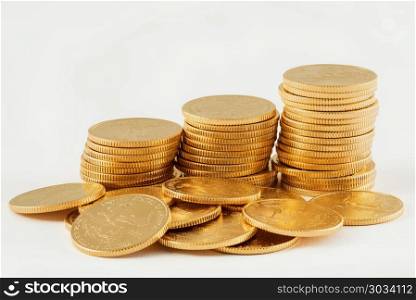 Stack of golden eagle coins. Gold Eagle one tenth ounce coins stacked into larger columns and isolated against white. Stack of golden eagle coins