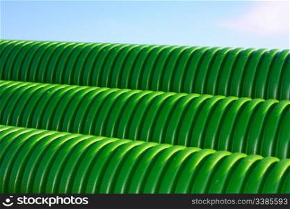 Stack of green tubes at a building site