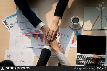 Stack of hands. Unity and teamwork concept. Close up top view of young business people putting their hands together