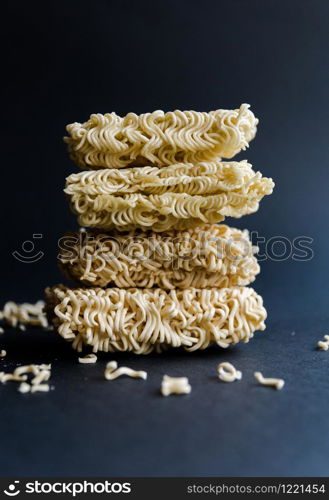 Stack of homemade instant noodles on black background.. Stack of homemade instant noodles on black background