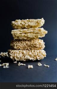 Stack of homemade instant noodles on black background.. Stack of homemade instant noodles on black background
