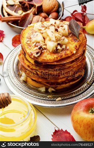 Stack of homemade pumpkin pancakes.Pumpkin pancakes with honey. Homemade pumpkin pancakes