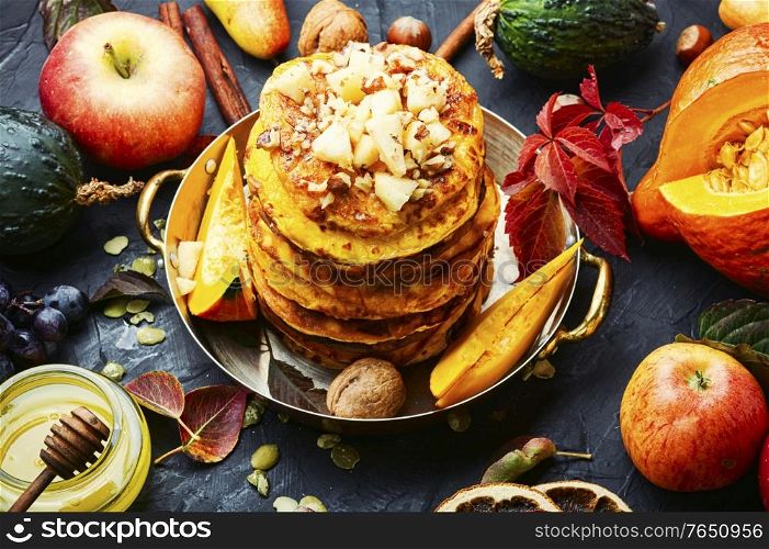 Stack of homemade pumpkin pancakes.Pumpkin pancakes with honey. Pumpkin pancakes with syrup