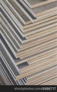 Stack of industrial plywood in construction site for background
