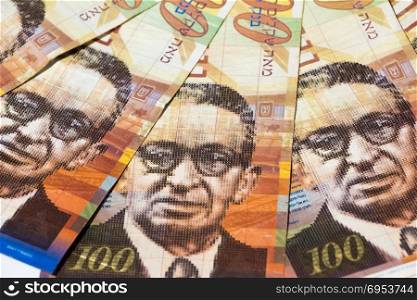 Stack of Israeli money bills of 100 shekel - top view.